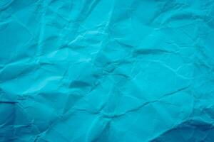 Crumpled paper background with blue color photo