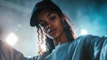 A young woman in a cap and sweater is posing photo
