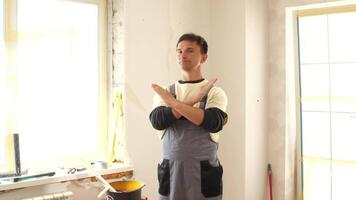 A man in an apron standing in a room with a window video