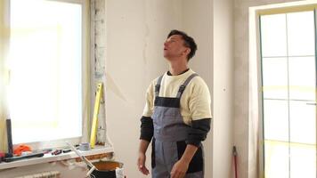 A man standing in a room with a paint brush video