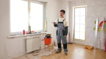 A man standing in front of a window with a bucket video
