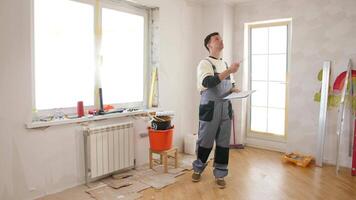 A man standing in a room with a clipboard video