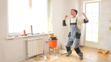 A man in an apartment with a bucket and a hammer video
