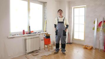A man standing in a room with a ladder and tools video