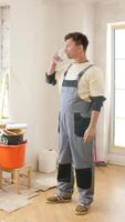 A man standing in a room with a bucket and a ladder video