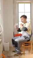 A man sitting on a chair with a glass of water video