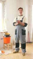 A man standing in a room with tools and a bucket video