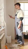 A man in overalls standing next to a radiator video