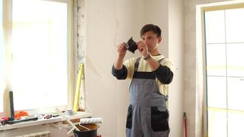 A man in overalls is holding a piece of paper video