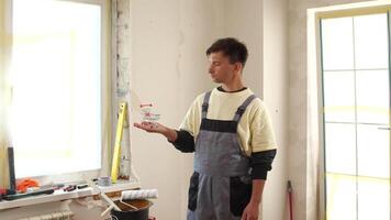 A man in overalls holding a paintbrush video