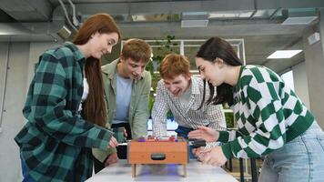 Students playing table football in classroom video