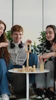 Teenagers playing jenga, building wooden block tower together video