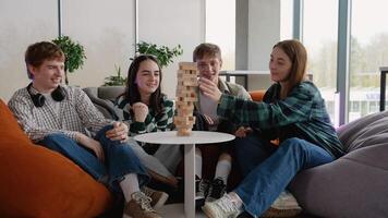 Students playing jenga board game and having fun video