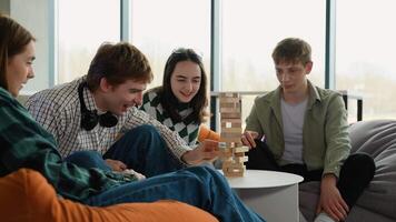 Teenagers playing jenga, having fun and enjoying their time together video