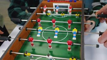 Students playing table football, intense game action video