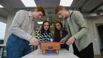 Students playing table football in classroom video