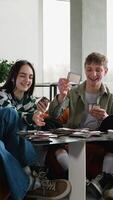 Teenagers playing cards and board games video