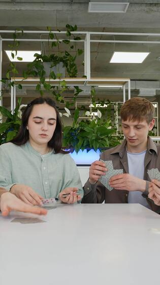Teenagers playing cards in modern - Teenagers Playing Cards In Modern Office Breakroom Video