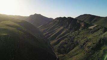 Mountain ridges cast shadows in a deep valley of Uzbekistan video