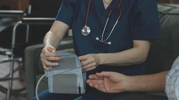 A nurse is holding a stethoscope while sitting on a couch video
