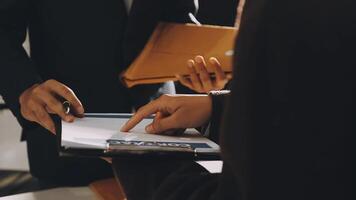 Two business people are holding a clipboard and looking at something video