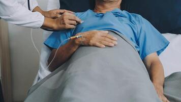 A man in a hospital bed with a doctor checking his heart rate video