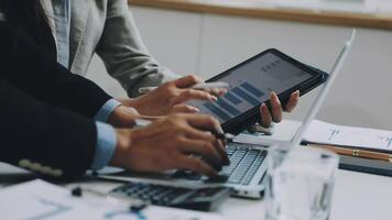 Business people using a tablet computer at a desk video