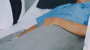 A man in a hospital bed with his hand on his stomach video