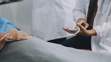 A doctor is checking the pulse of an elderly patient video