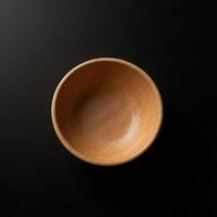 Wooden Bowl Isolated on Black Background for Food Presentation photo