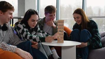 Teenagers playing jenga, having fun and spending time together video