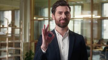 Caucasian businessman smiling in office showing ok sign business man portrait happy middle-aged male employer guy okay hand gesture satisfied entrepreneur at workplace success approve good recommend video