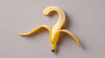 Banana Peel Curls Into Whimsical Question Mark Shape, Adding Humor to Ordinary Setting photo