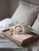 Cozy Recovery Setup on a Bed Tray With Medicine, Water, and a Book for a Chilly Day of Rest and Relaxation photo