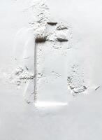 Imprint of perfume bottle on surface of sand. Perfume advertising concept photo