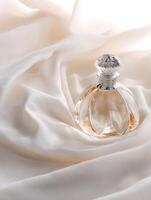 Elegant Perfume Bottle on Draped Fabric. A luxurious still life image of a beautiful perfume bottle resting on creamy silk. photo