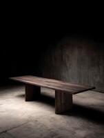 Long Rustic Wooden Table on Concrete Floor, Dark Studio Setting. photo