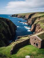 Coastal Stone Structure on Dramatic Cliffs, Scotland. A picturesque scene of a historic stone building overlooking a rugged coastline. photo