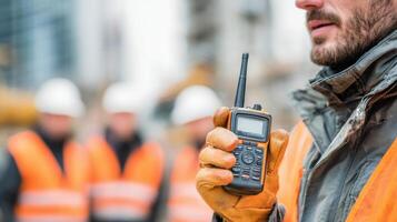 Teamwork in Action With a Man Using a Walkie-Talkie in a Construction Environment During Collaborative Project Planning photo