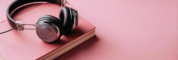 Headphones Resting on a Notebook Symbolize the Essence of Listening and Creativity in a Calm, Minimalistic Setting photo