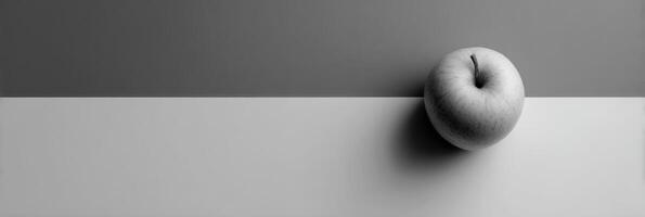 Minimalist Grayscale Composition Featuring a Single Colored Apple Against an Empty Right Side Background photo