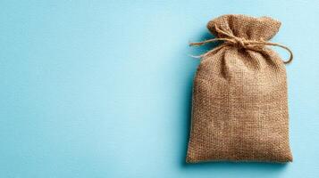 Eco-friendly Burlap Packaging With a Clean Sky-Blue Background photo
