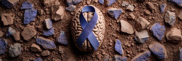 Clay Brain Sculpture Surrounded by Blue PTSD Awareness Ribbon on Textured Surface photo