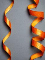 Floating Orange Zest Ribbon Creates a Vibrant Visual Against a Minimalistic Matte Background photo