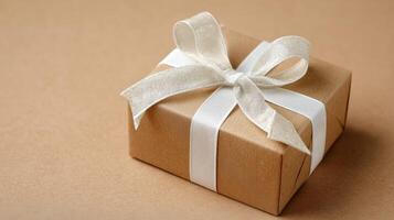 Wrapped Gift With White Ribbon Displayed on a Tan Surface in a Cozy Setting photo