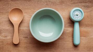 Feeding Tools Arranged on Clean Wooden Surface With Scoop, Timer, and Bowl Ready for Use in Meal Preparation photo