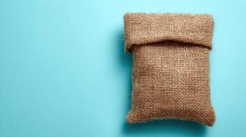 Eco-friendly Packaging on Burlap Cloth Against a Clean Sky-Blue Backdrop Showcasing Sustainable Choices in Product Design photo