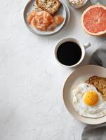 Breakfast Setup for Pet Featuring Toast, Salmon, Egg, Grapefruit, Coffee, and Oatmeal in a Cozy Kitchen photo