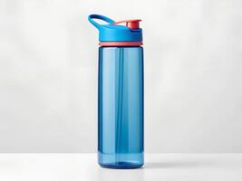 Blue Plastic Water Bottle with Red Lid and Straw on White Background photo