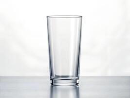 Empty Clear Glass on Grey Surface, Minimalist Studio Shot photo